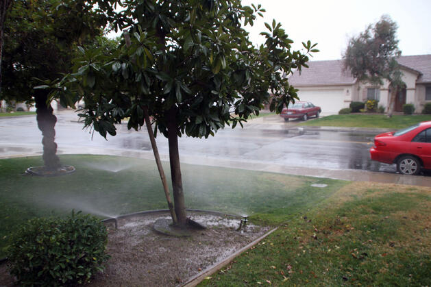 irrigation system running during a rain storm